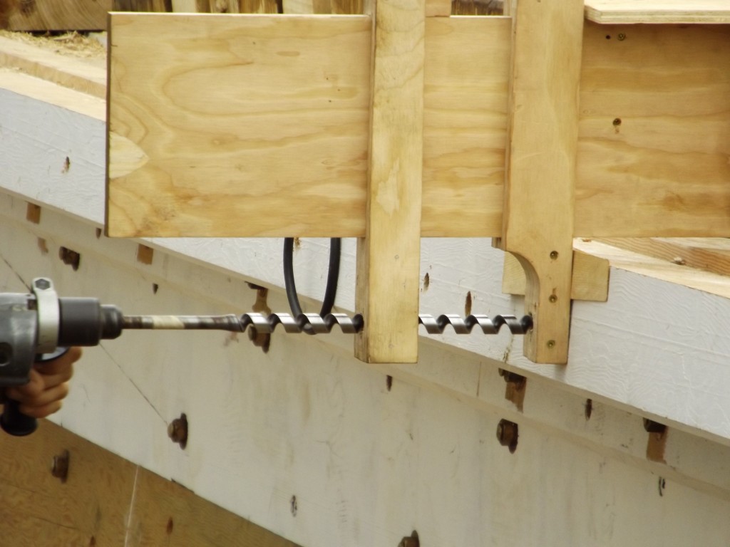 The crew developed this ingenious jig to guide the drill bit true.