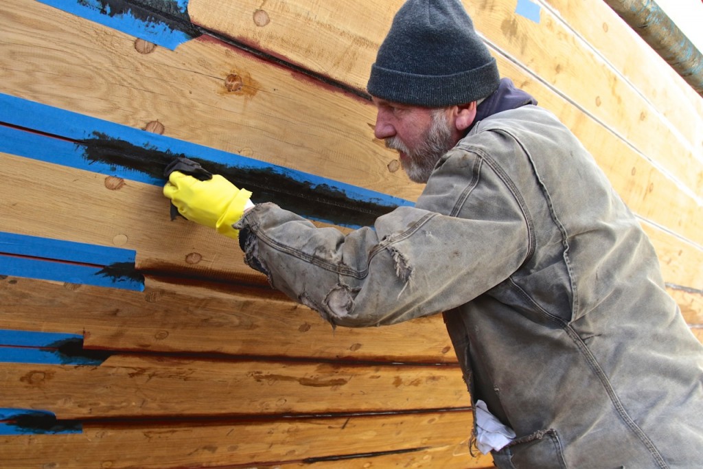 Below the waterline a mixture of roofing tar/Portland cement is being applied to seal the seam with the cotton and oakum already in place. credit Robert Mitchell