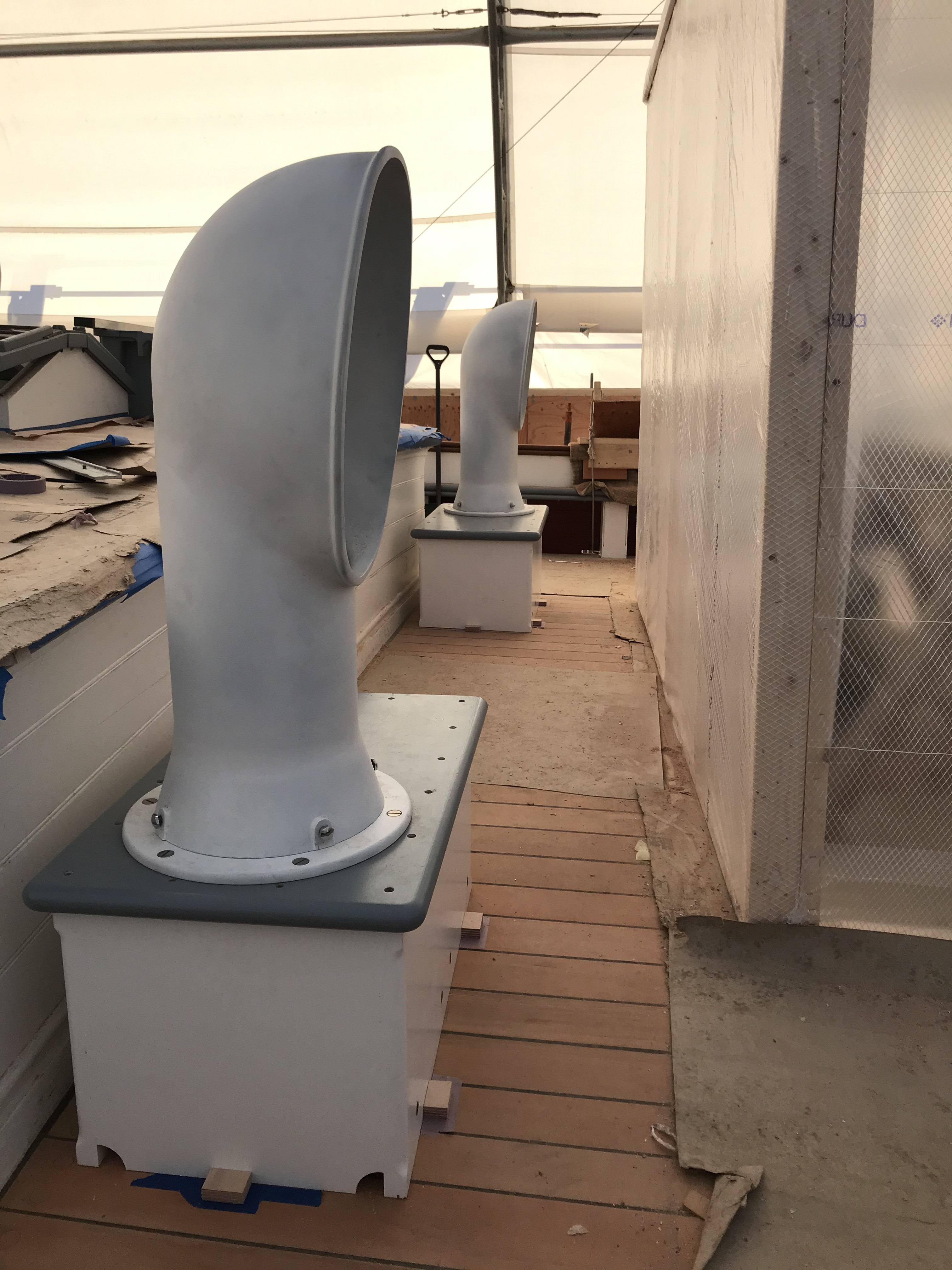 These large ventilators have been placed and installed on top of their respective dorade boxes.  These are quite large, and look terrific as a pair.  The dorade boxes were built specifically to match the exact camber of the deck while remaining level along the top surface.  Unlike other ventilators on the ship, these two have a very important purpose.  These provide a specific volume of air to adequately ventilate the Engine Room.  The port side ventilator is designated as the intake, while the starboard side will be mated to an exhaust fan in the engine compartment to cycle the air through the space.  Like everything on a ship, they are beautiful but also serve a purpose.
