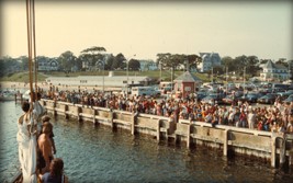 1982-The crowd waits for Ernestina to come alongside at Onset Town Pier enroute to Gloucester to be laid up for the winter and await work.