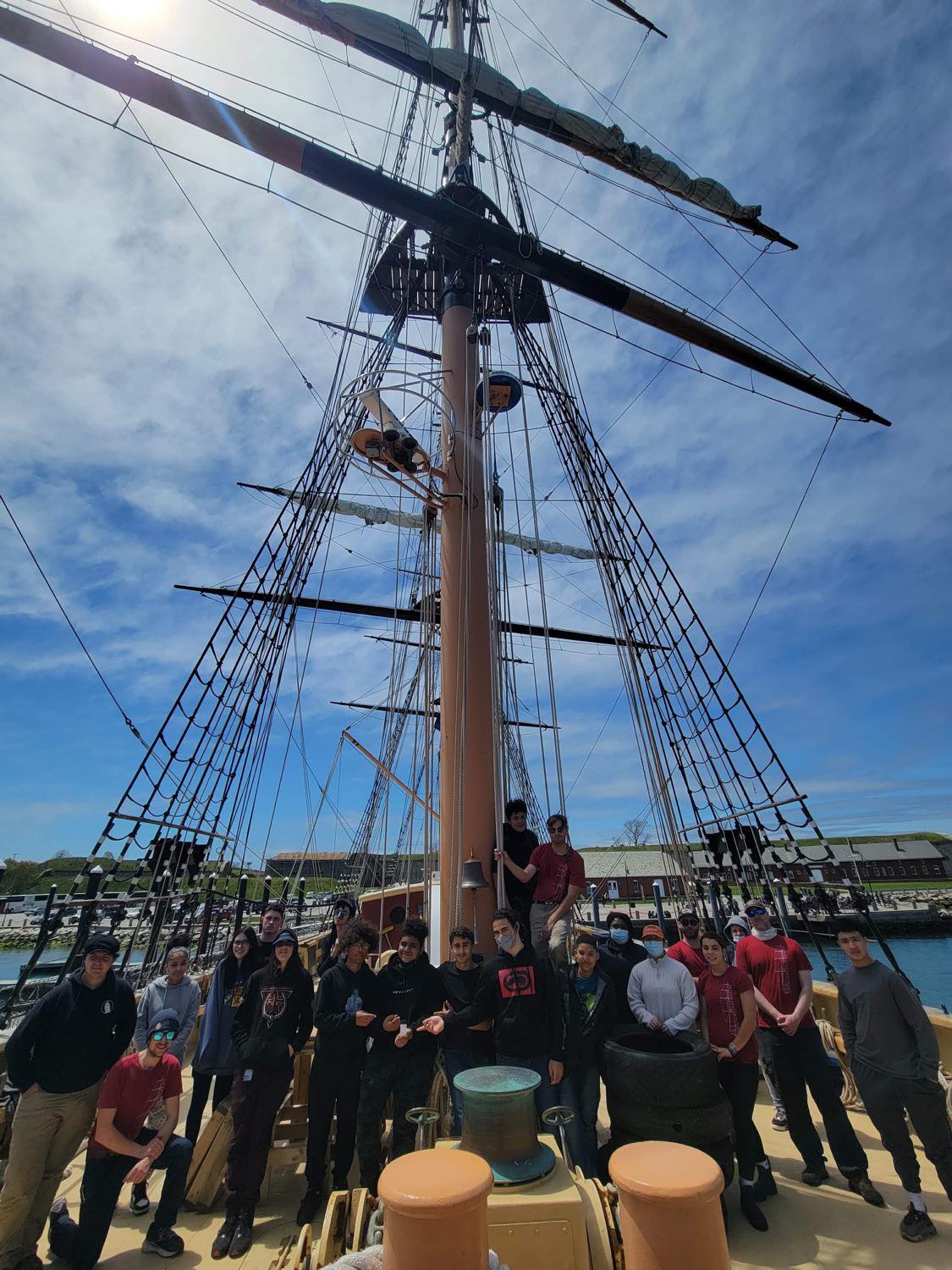 The crew and trainees aboard the SSV Oliver Hazard Perry with their water sample.