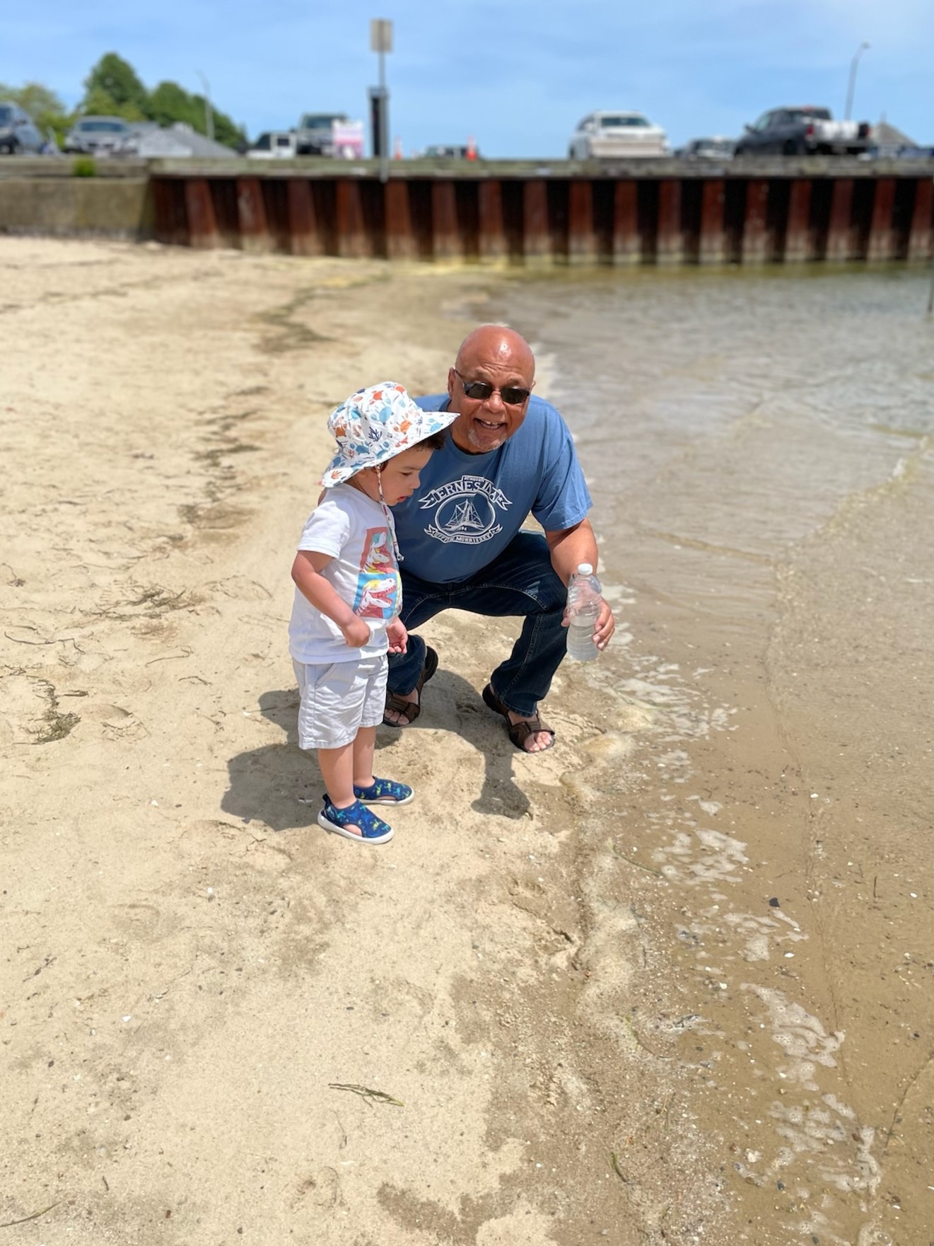 Julius Britto amd Grandson Elliot collecting water at Onset Pier.