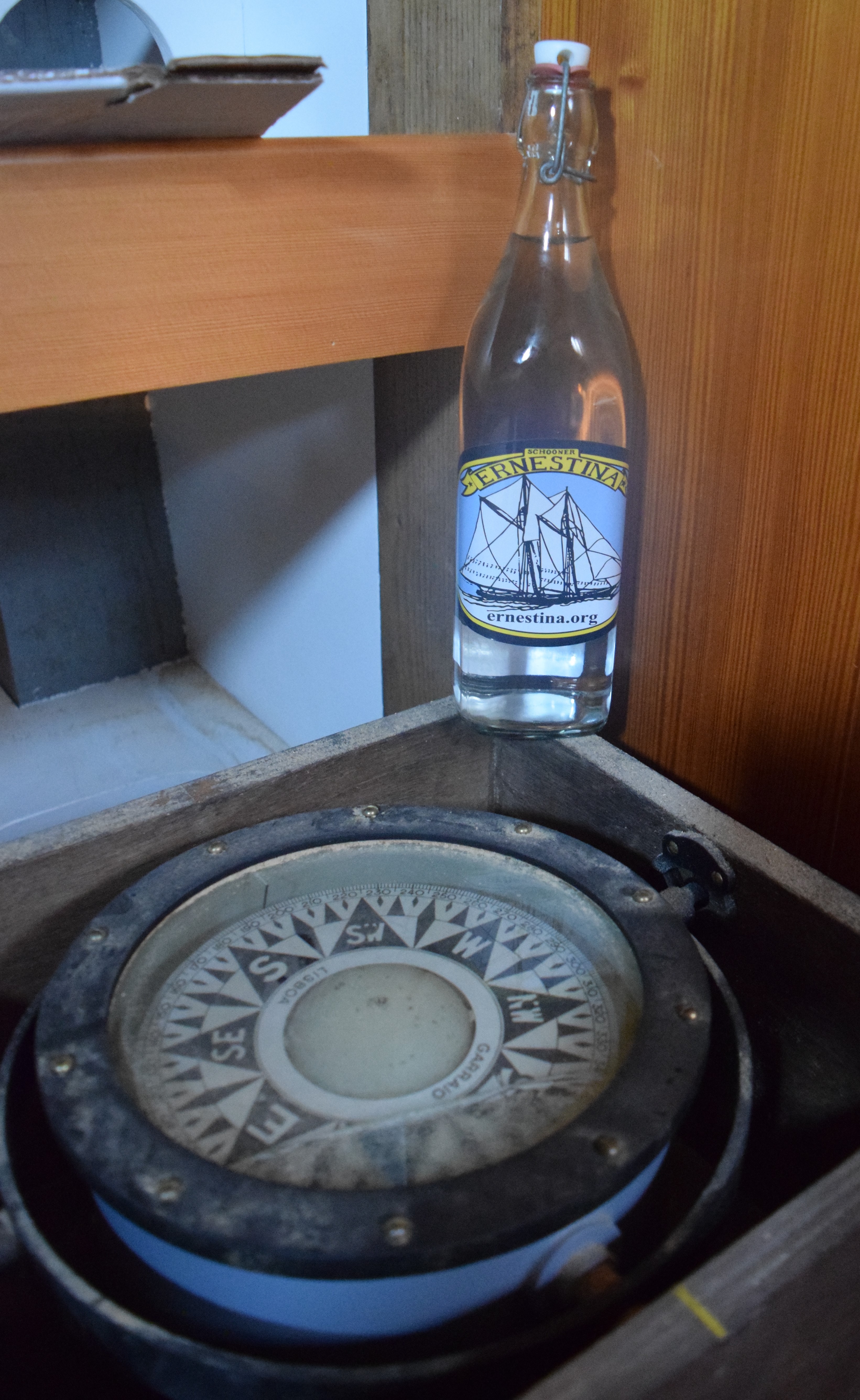 The bottle of mingled waters on Ernestina’s newly-restored aft-cabin compass. With the taste of those waters and this compass the vessel will know where to go!
