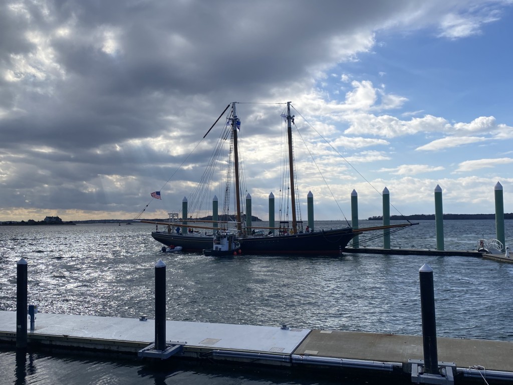 The wind was pushing Ernestina-Morrissey away from the dock.  The push boat and the Tug Hercules helped as the crew moored her at her berth at the Academy. Photo Credit Gene Monteiro